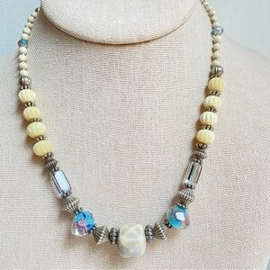 Beaded necklace with clear glass cream acrylic and silvertone metal mixed media